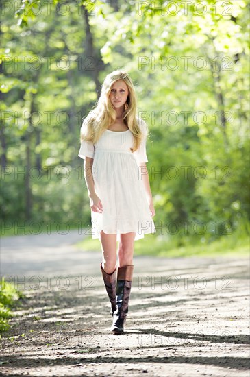 Caucasian woman walking on dirt path