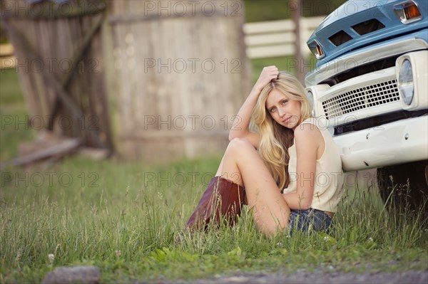 Caucasian woman sitting near truck