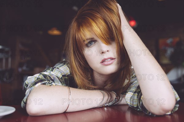 Caucasian woman leaning on table