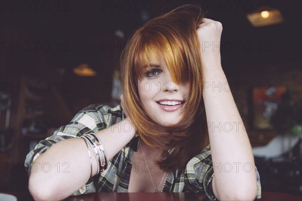 Caucasian woman leaning on table