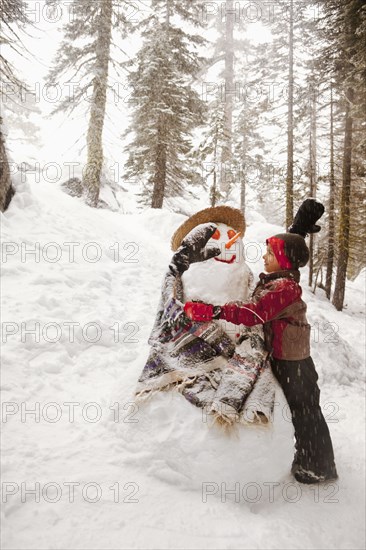 Girl hugging snowman