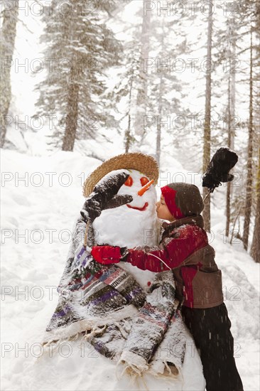 Girl kissing snowman