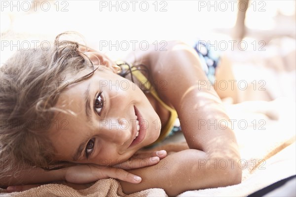 Smiling mixed race girl sunbathing