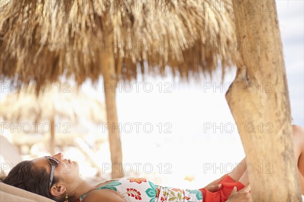 Tranquil Hispanic woman relaxing on vacation