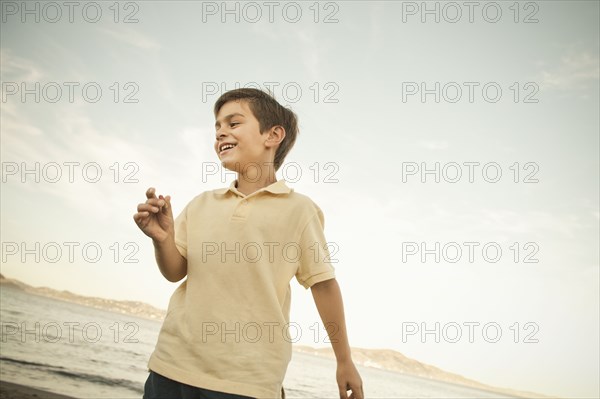 Mixed race boy enjoying beach