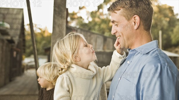 Caucasian father and children outdoors