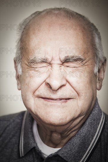 Senior Hispanic man with eyes closed