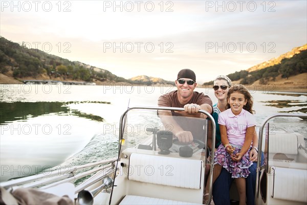 Girl and parents enjoying riding on boat