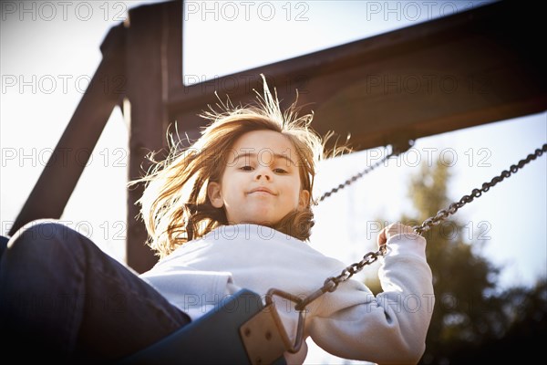 Caucasian girl swinging