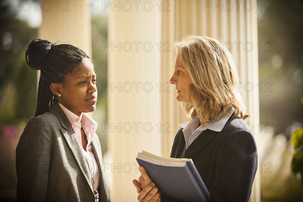 Businesswomen talking together outdoors