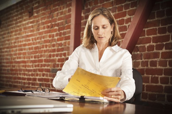 Caucasian businesswoman working in office