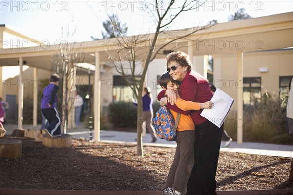 Hispanic grandmother hugging grandson