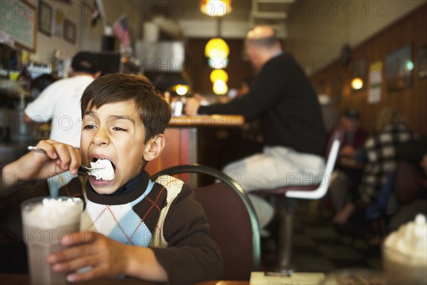 Mixed race boy eating ice cream