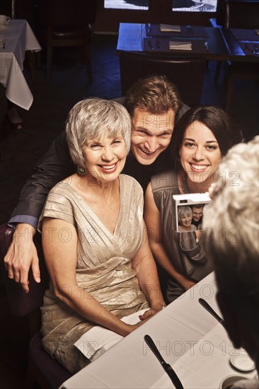 Man photographing friends in restaurant