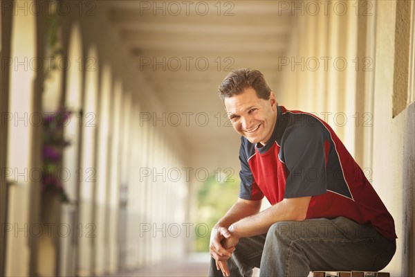 Smiling Caucasian man sitting outdoors