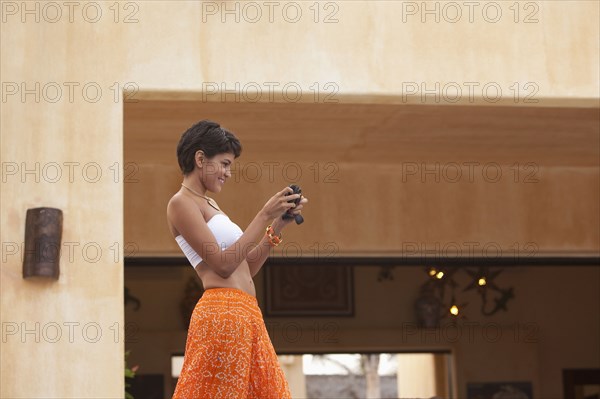 Hispanic woman using digital camera