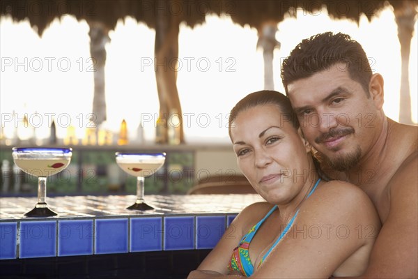 Hispanic couple drinking cocktails