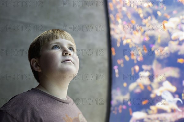 Serious boy visiting aquarium