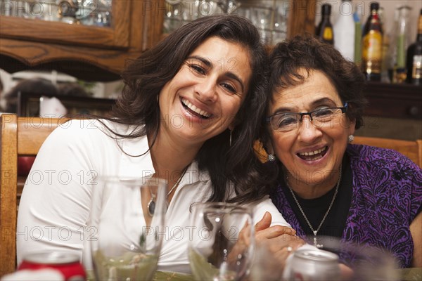 Hispanic mother and daughter at Thanksgiving dinner