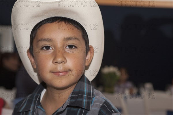 Hispanic boy wearing cowboy hat