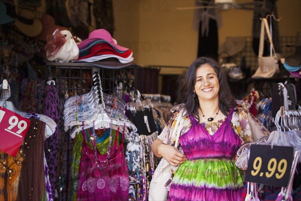 Hispanic woman shopping for dress