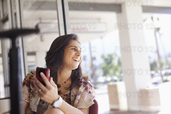 Hispanic woman holding cell phone