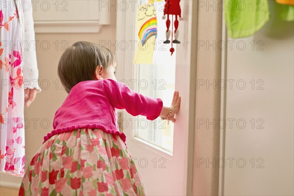 Hispanic girl looking out door