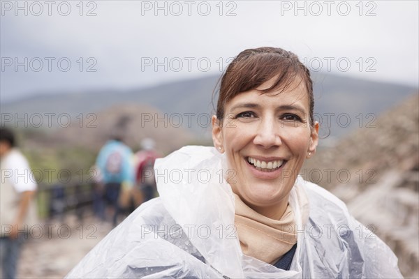 Smiling Hispanic woman in rain coat