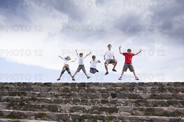Children jumping on top of steps