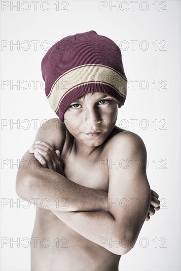 Angry mixed race boy with arms crossed