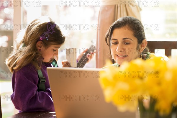 Mother shopping online with daughter