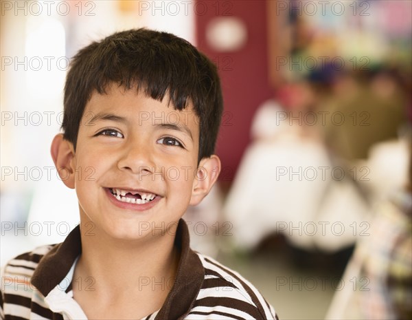 Hispanic boy smiling with gap in his teeth