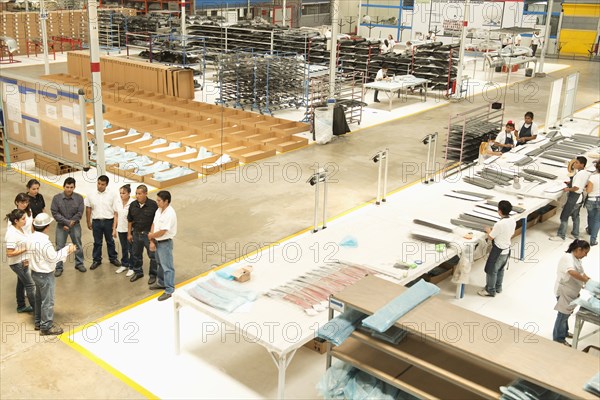 Workers talking in manufacturing plant