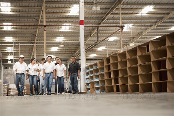 Workers talking in manufacturing plant