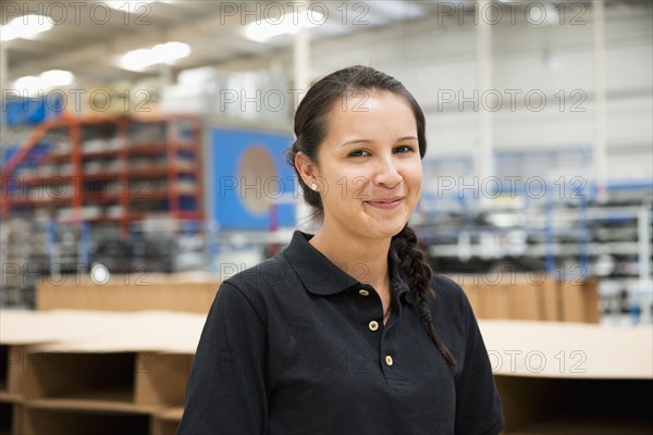 Worker smiling in manufacturing plant