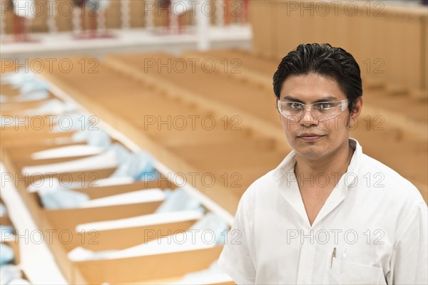 Worker standing in manufacturing plant