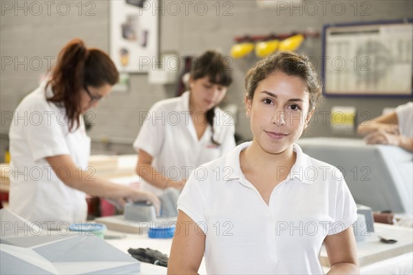 Worker smiling in manufacturing plant