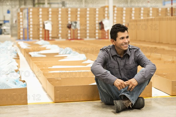 Worker smiling in manufacturing plant