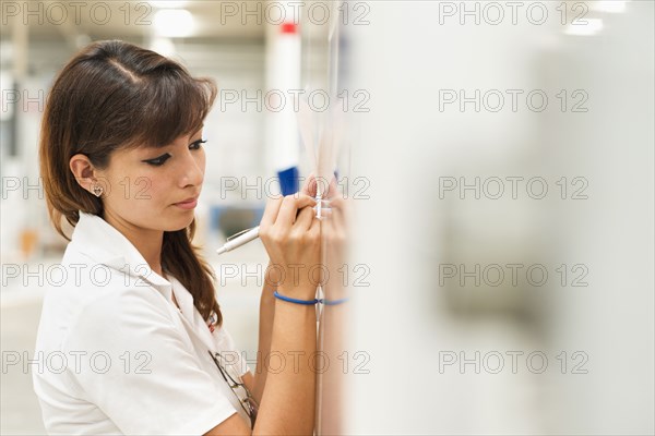 Worker writing on whiteboard