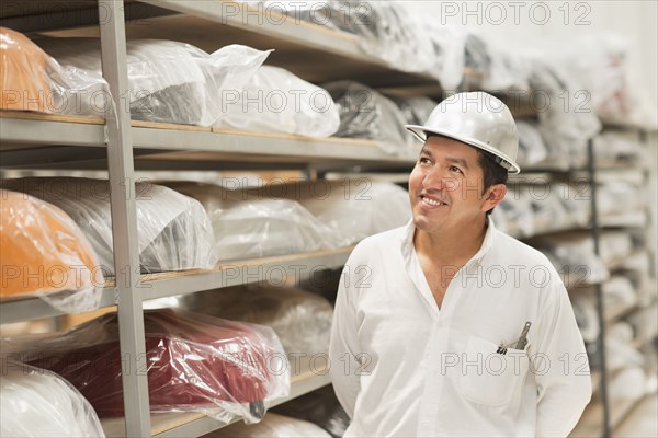 Worker smiling in manufacturing plant