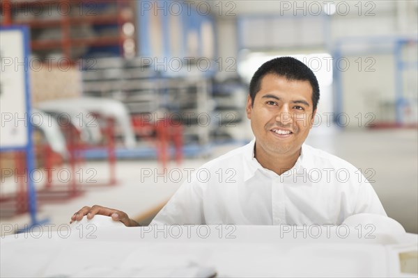 Worker smiling in manufacturing plant