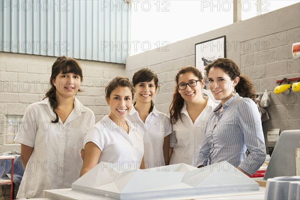 Workers smiling in manufacturing plant