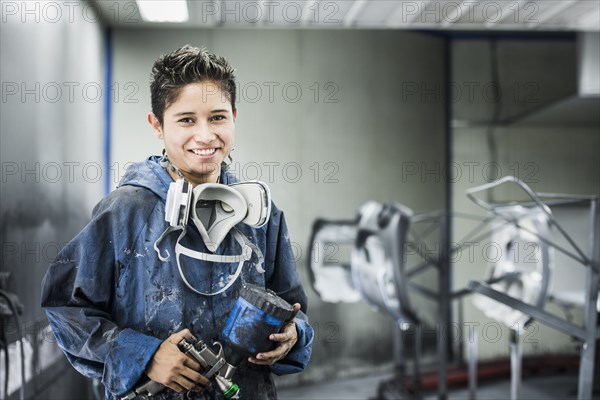 Worker smiling in manufacturing plant