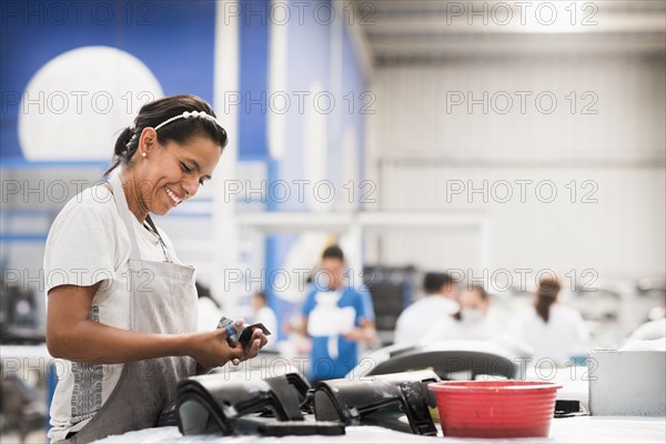 Worker smiling in manufacturing plant