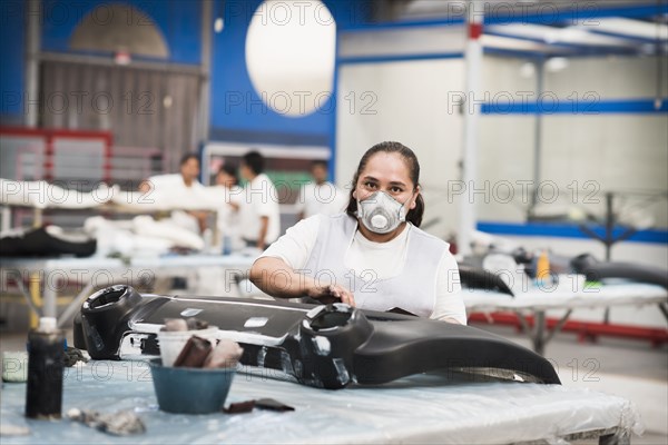 Worker wearing face mask in manufacturing plant