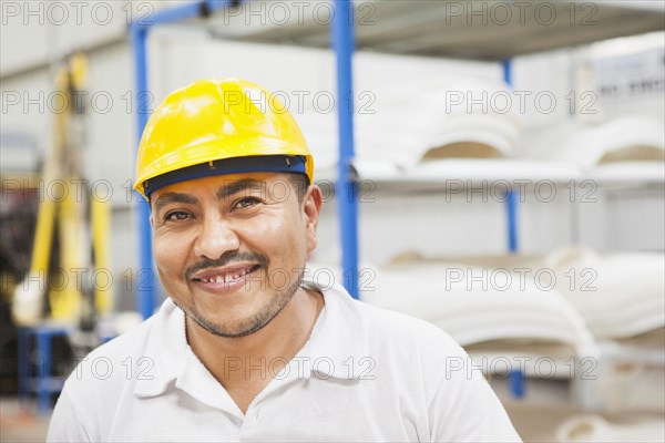 Worker smiling in manufacturing plant