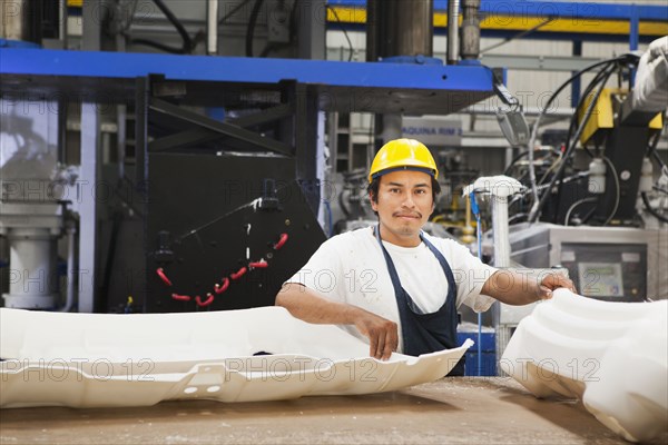 Worker smiling in manufacturing plant