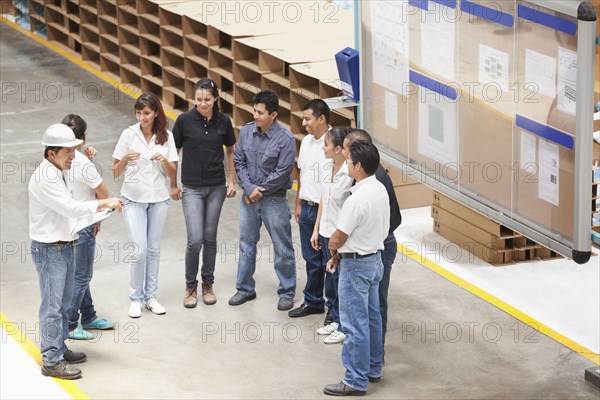 Workers talking in manufacturing plant