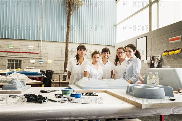 Workers smiling in manufacturing plant