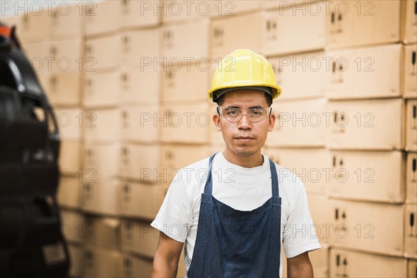 Worker standing in manufacturing plant